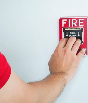 man-is-reaching-his-hand-to-push-fire-alarm-hand-station